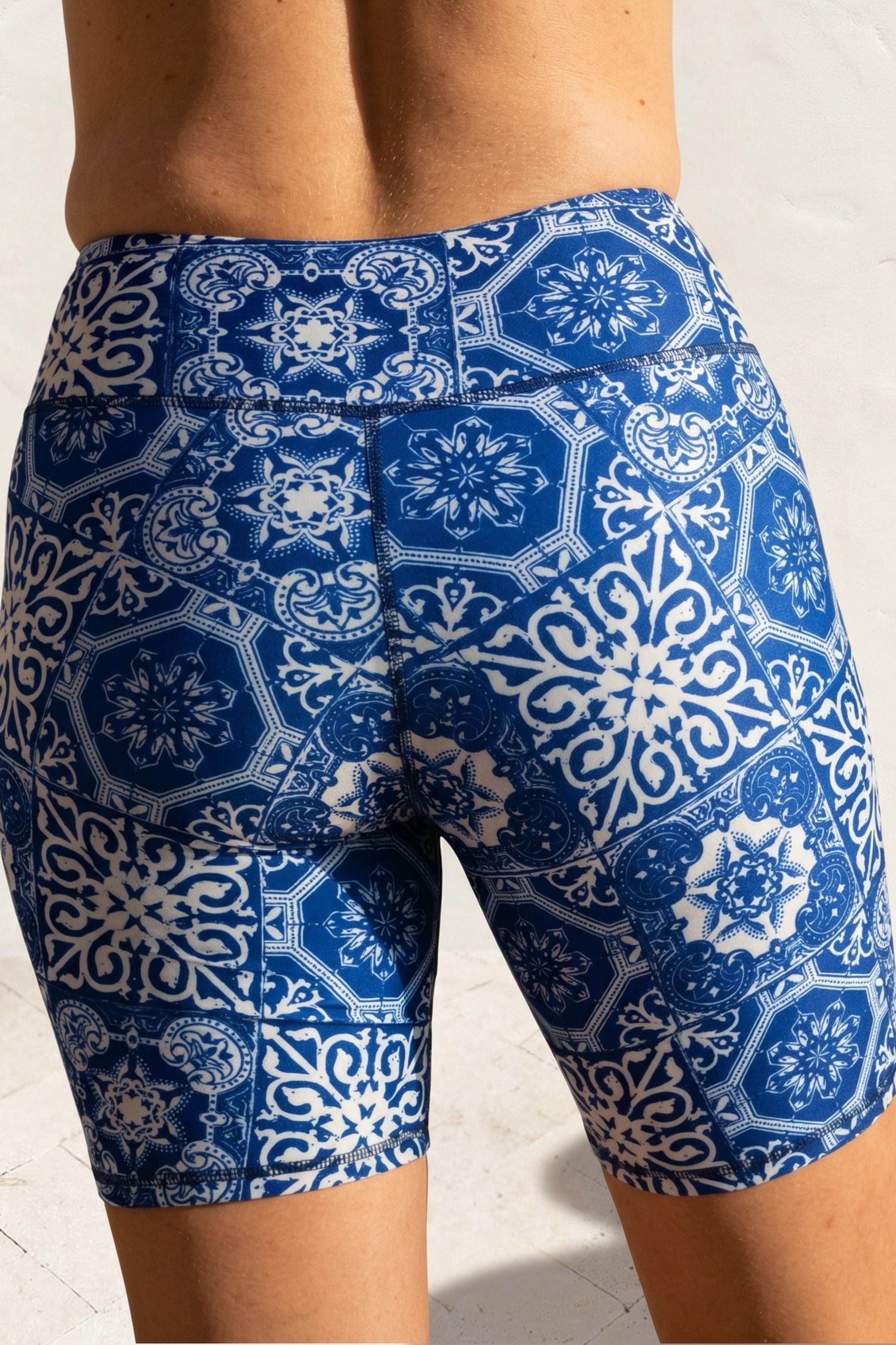 Blue and white patterned shorts on a neutral background