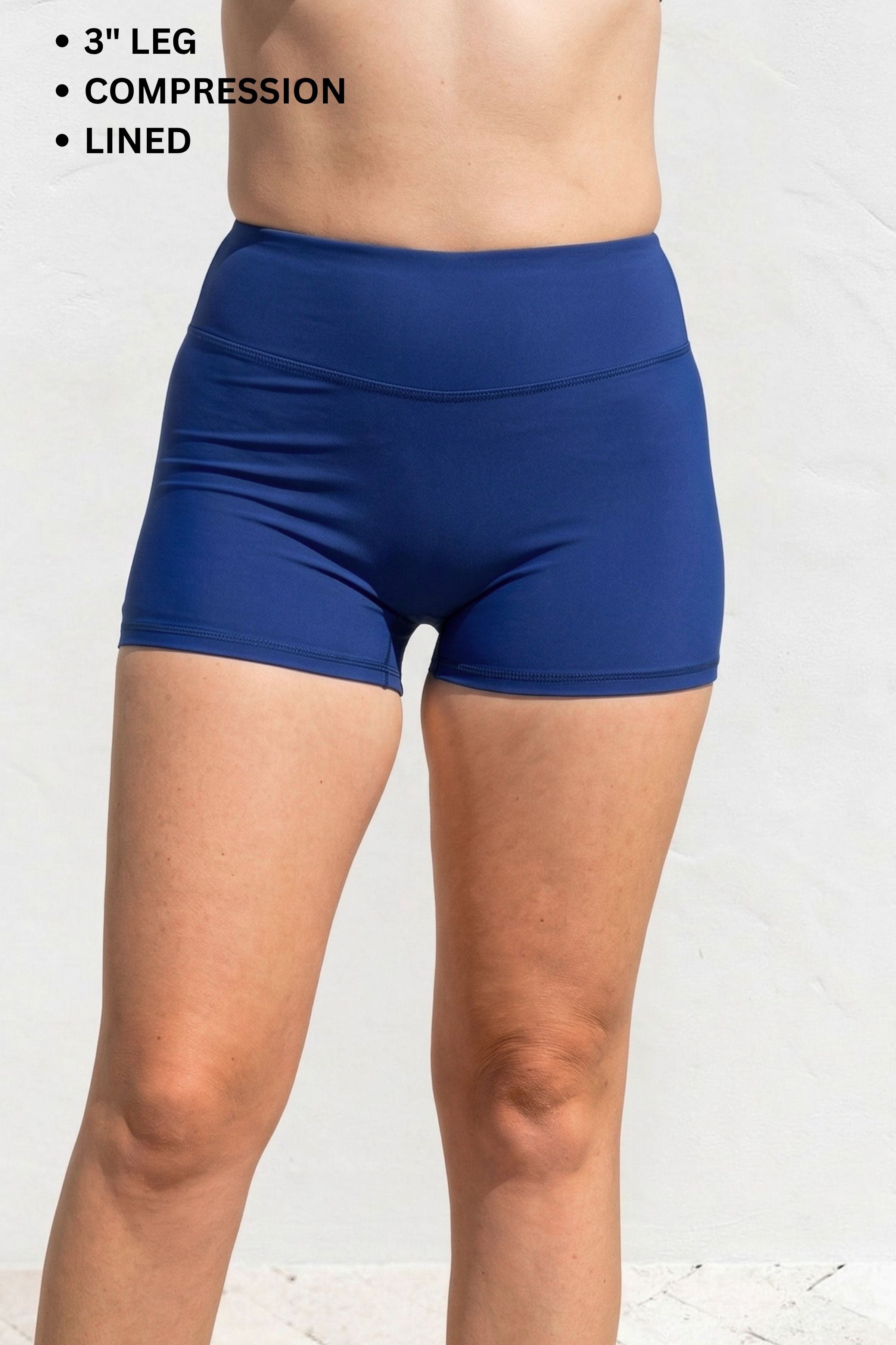 Blue compression shorts worn by a person on a white background