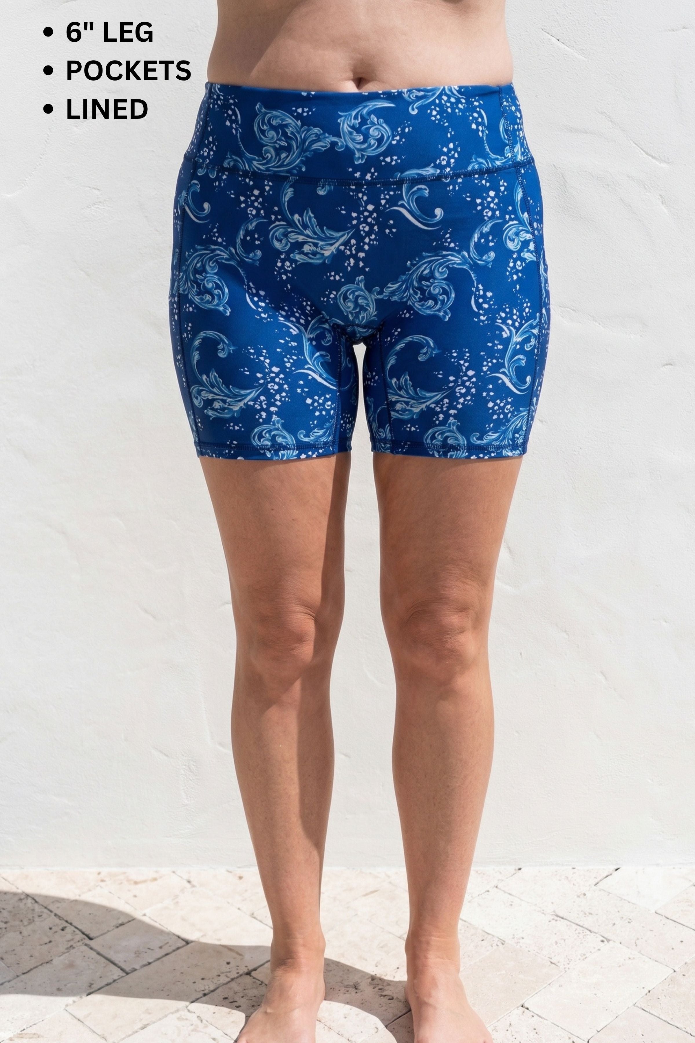 Blue patterned shorts worn by a person on a white background