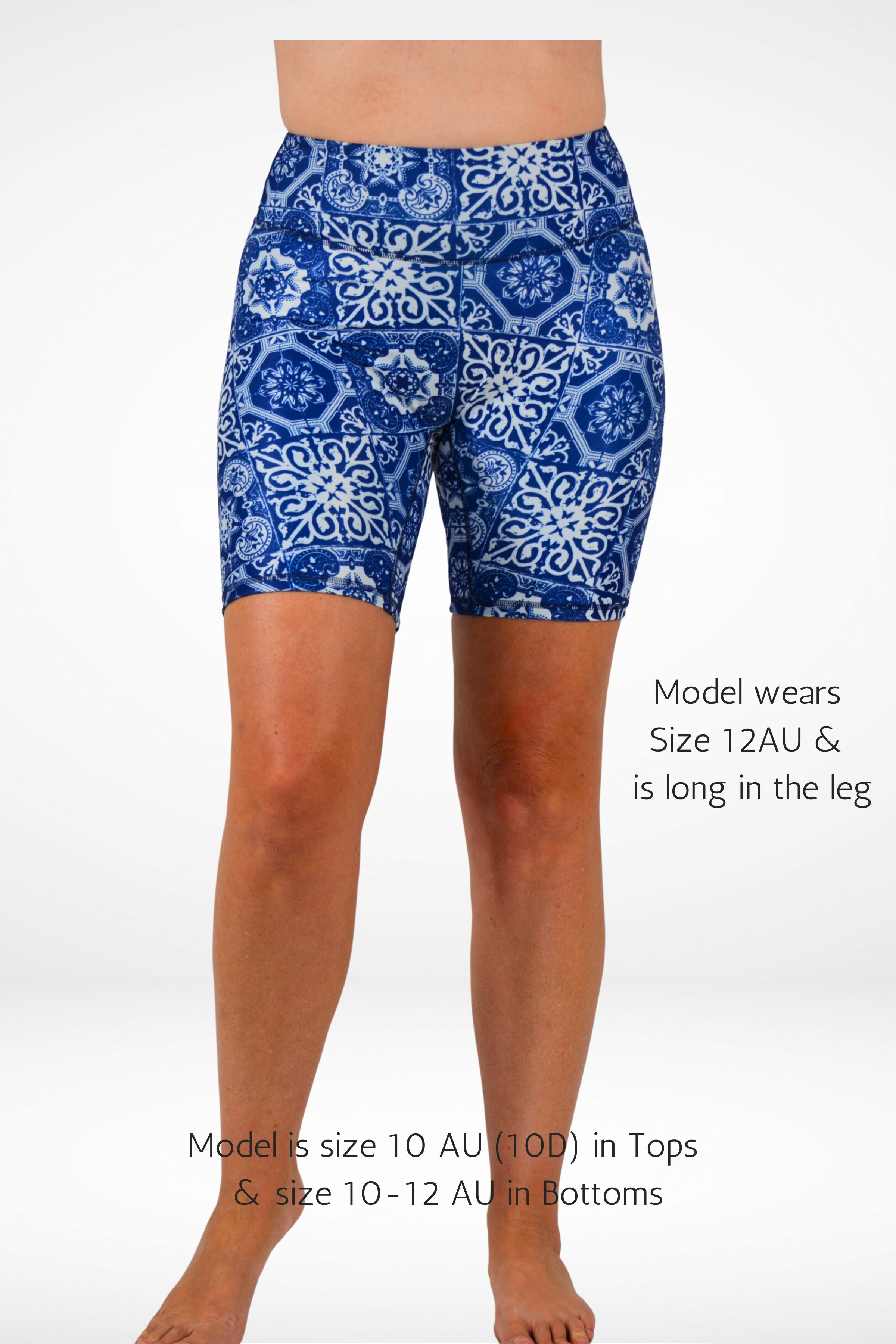 Blue patterned shorts worn by a model on a white background