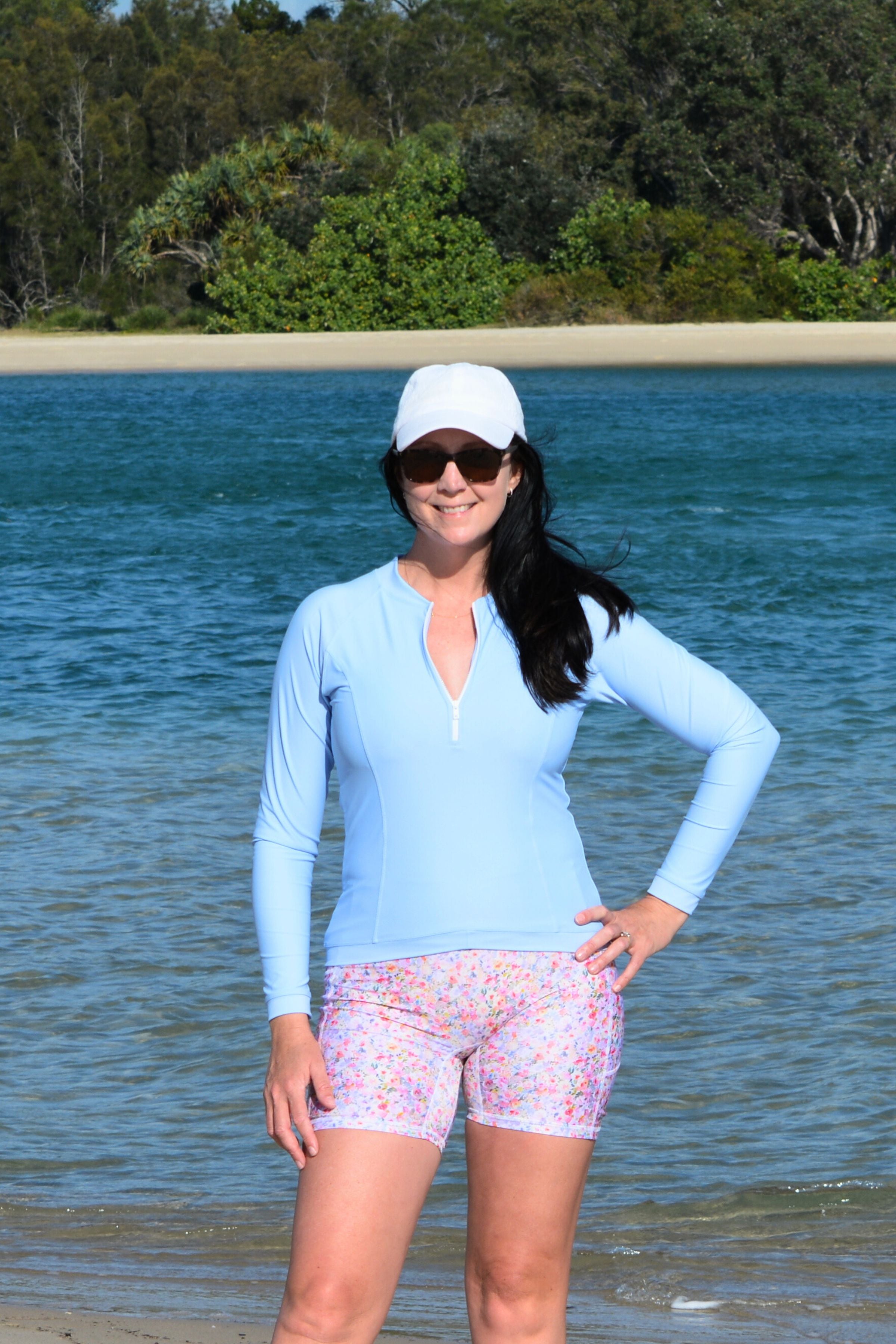 women wearing light blue long sleeve rash guard and floral bike shorts