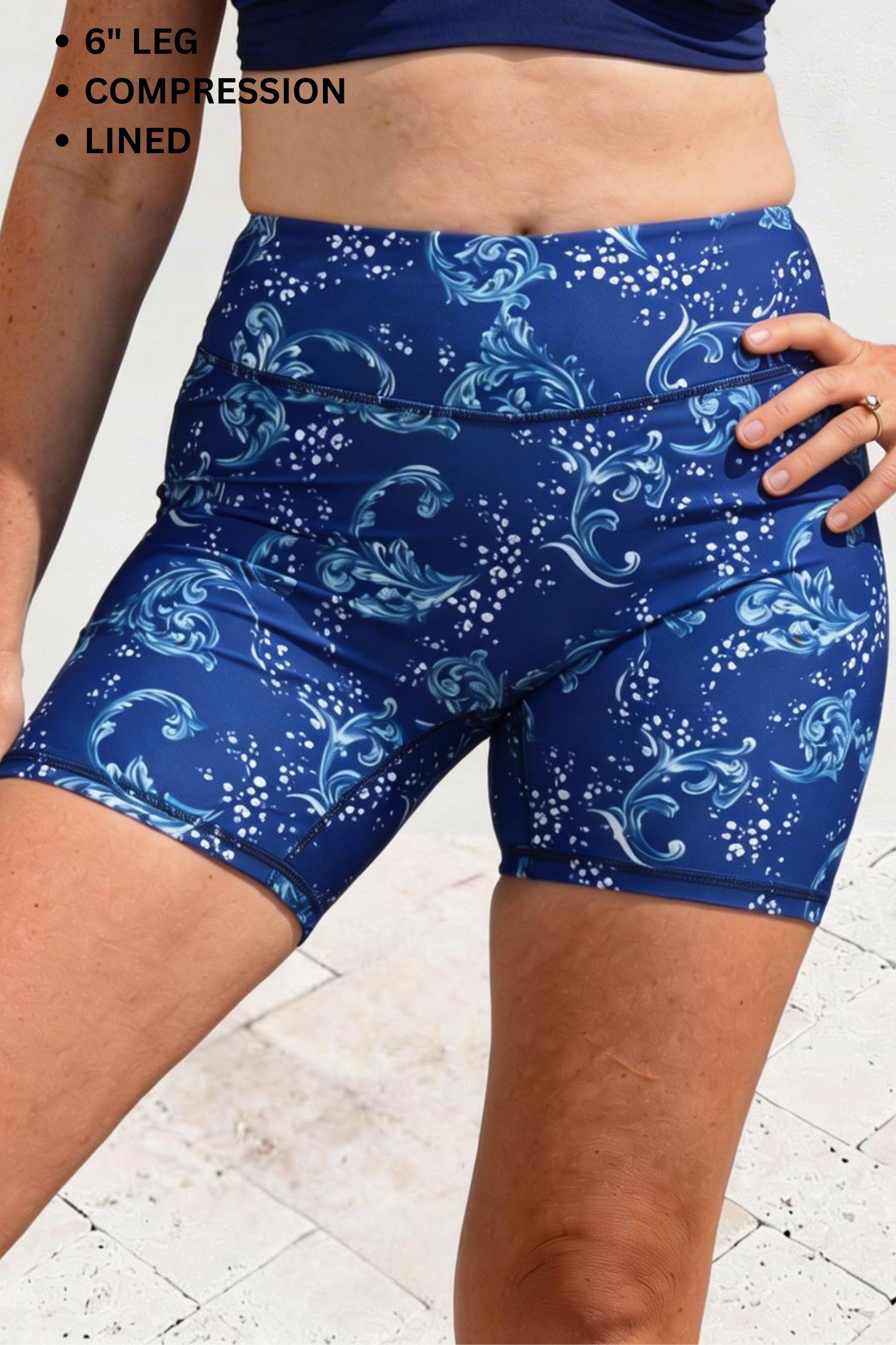 Blue patterned compression shorts worn by a person on a white background