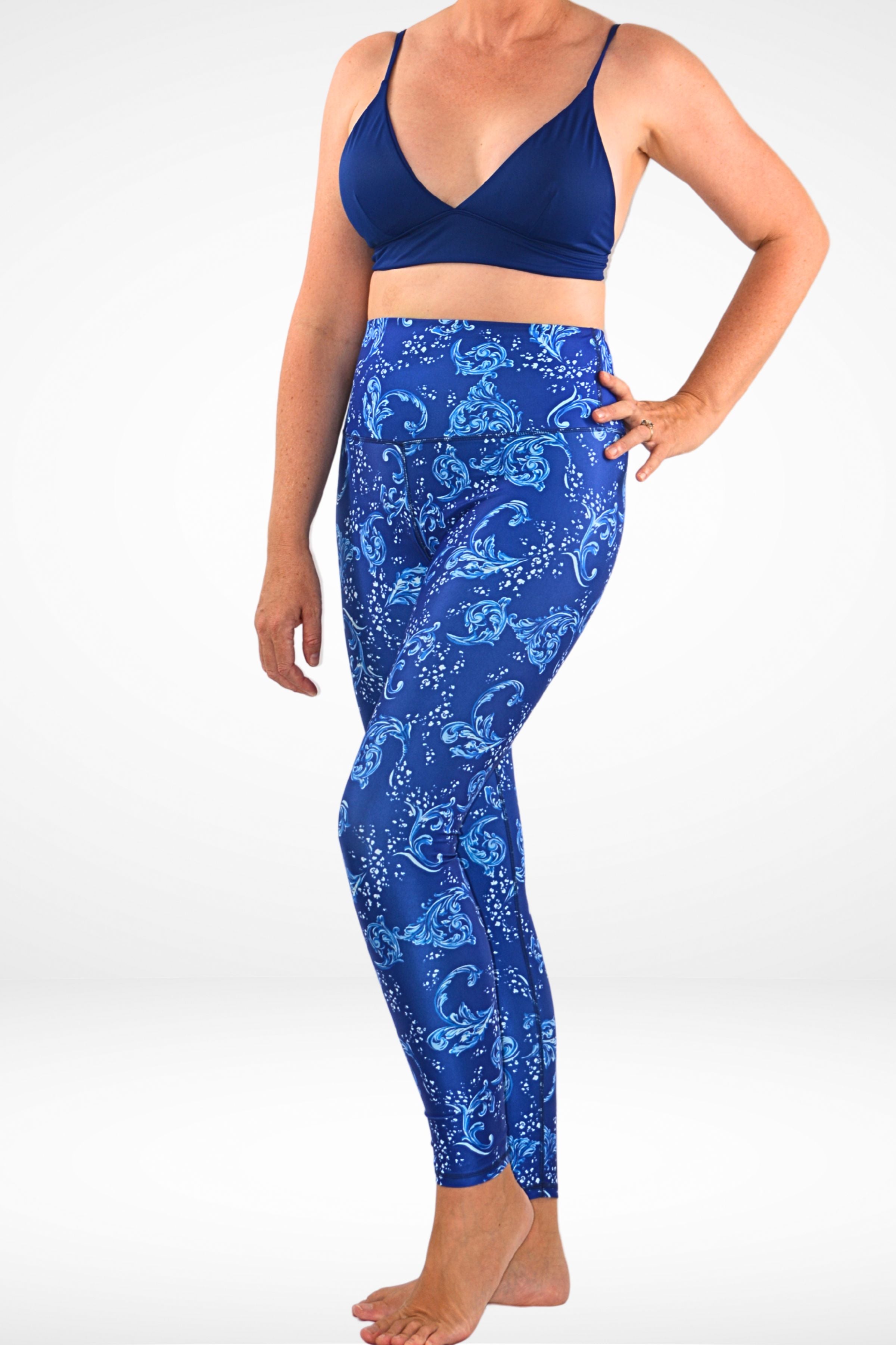 women wearing andavi swim blue and white print swim legging and navy blue triangle bikini top