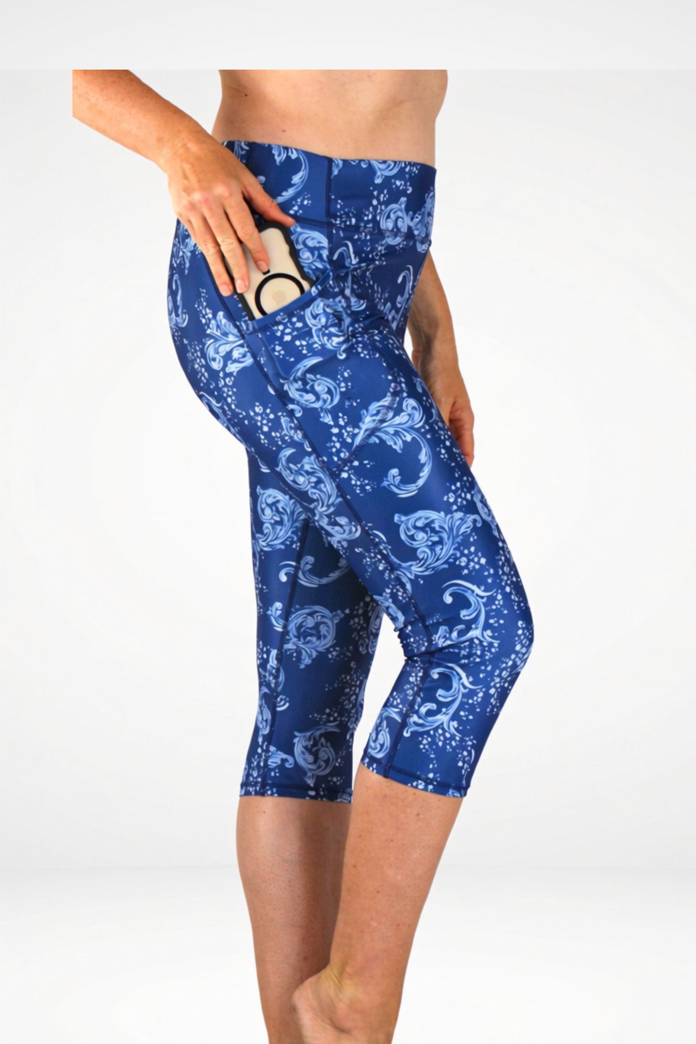 Blue patterned leggings worn by a person on a white background