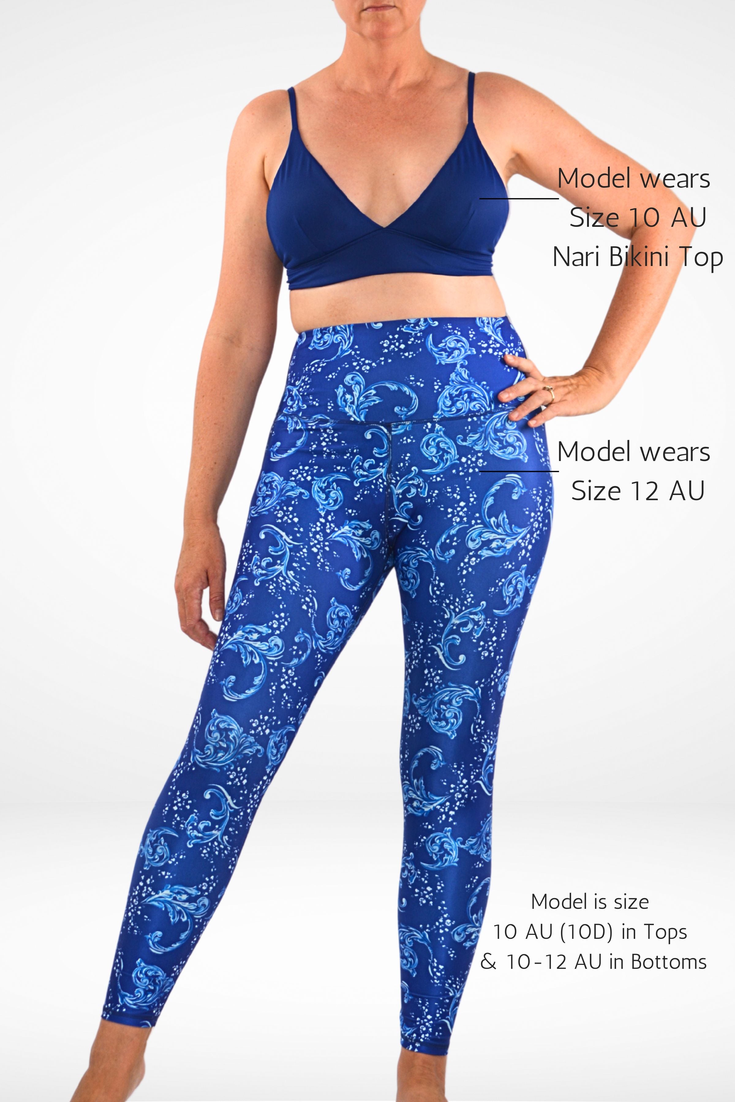 women wearing andavi swim blue and white print swim legging and navy blue triangle bikini top