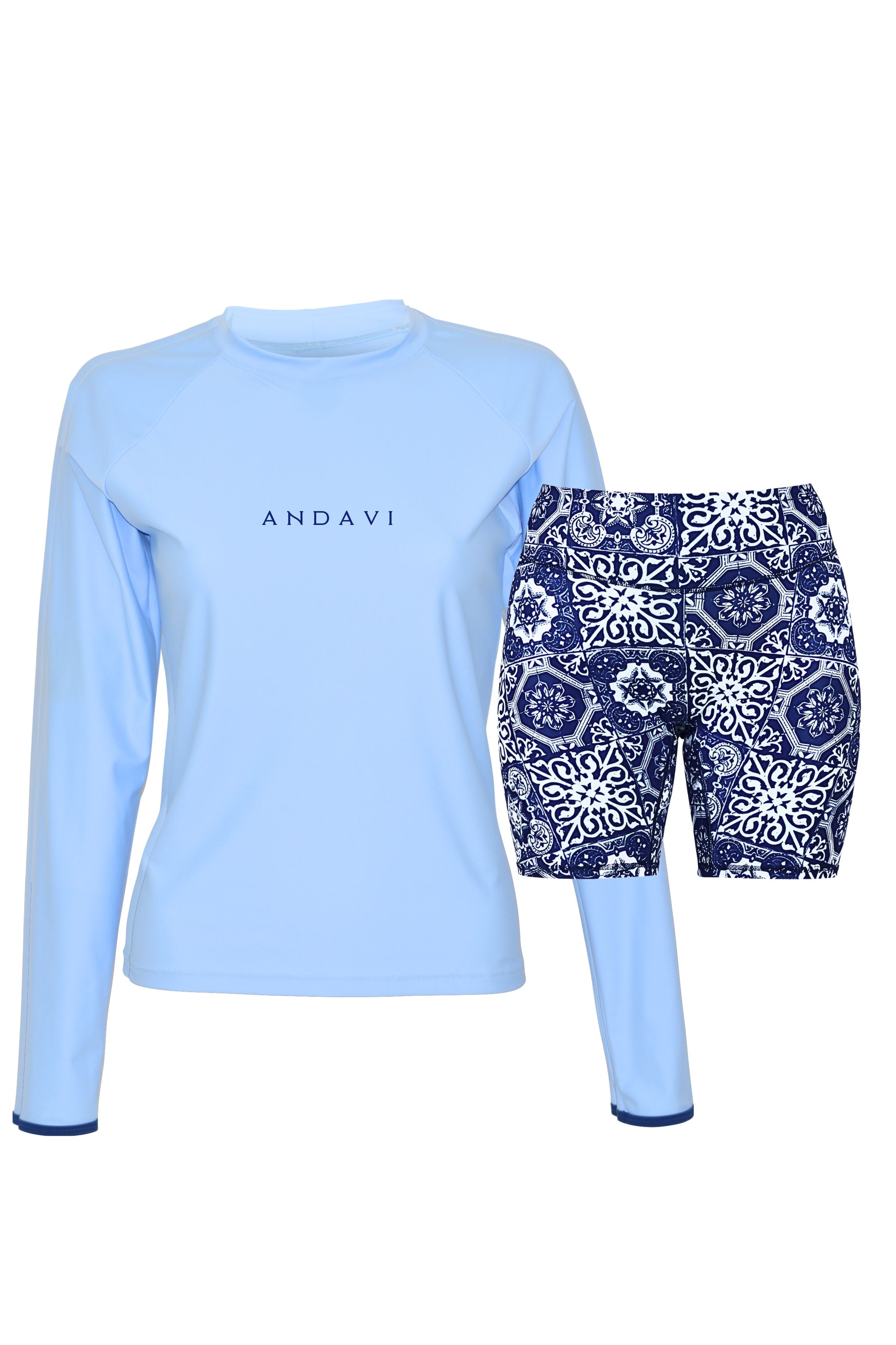 Light blue long-sleeve top and navy patterned shorts on a white background