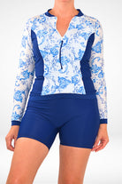 women wearing navy blue and white andavi long sleeve rash guard and long leg navy blue modest swim shorts