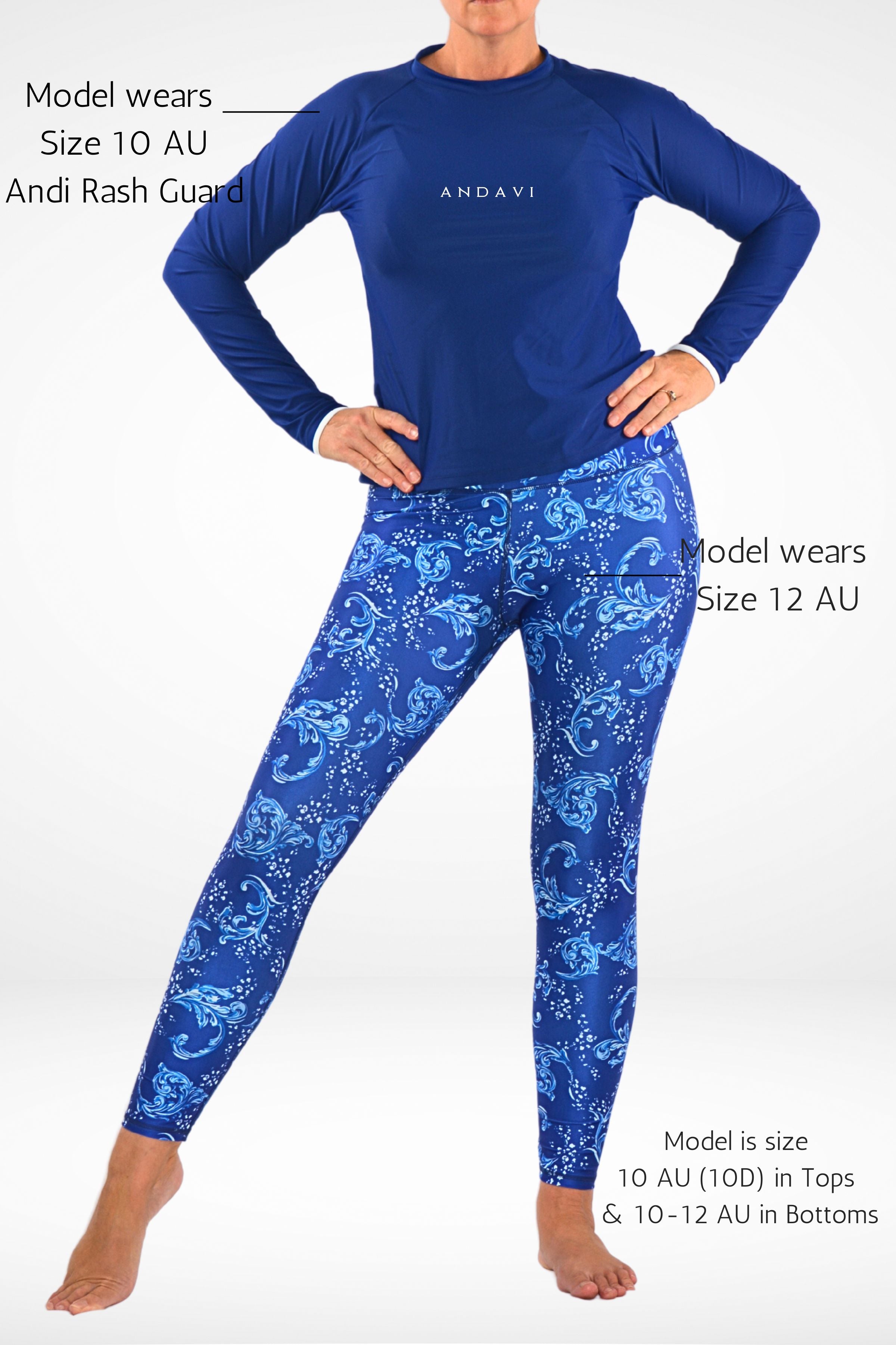Person wearing a blue Rash Guard and patterned leggings on a white background