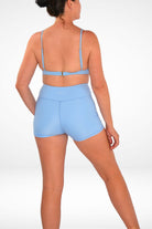 women wearing light blue bikini top and matching light blue swim shorts