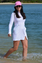 women at the beach wearing andavi swim pink cap and andavi swim long sleeve white swim active dress cover up