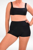 women wearing black square neck bikini top and black swim shorts