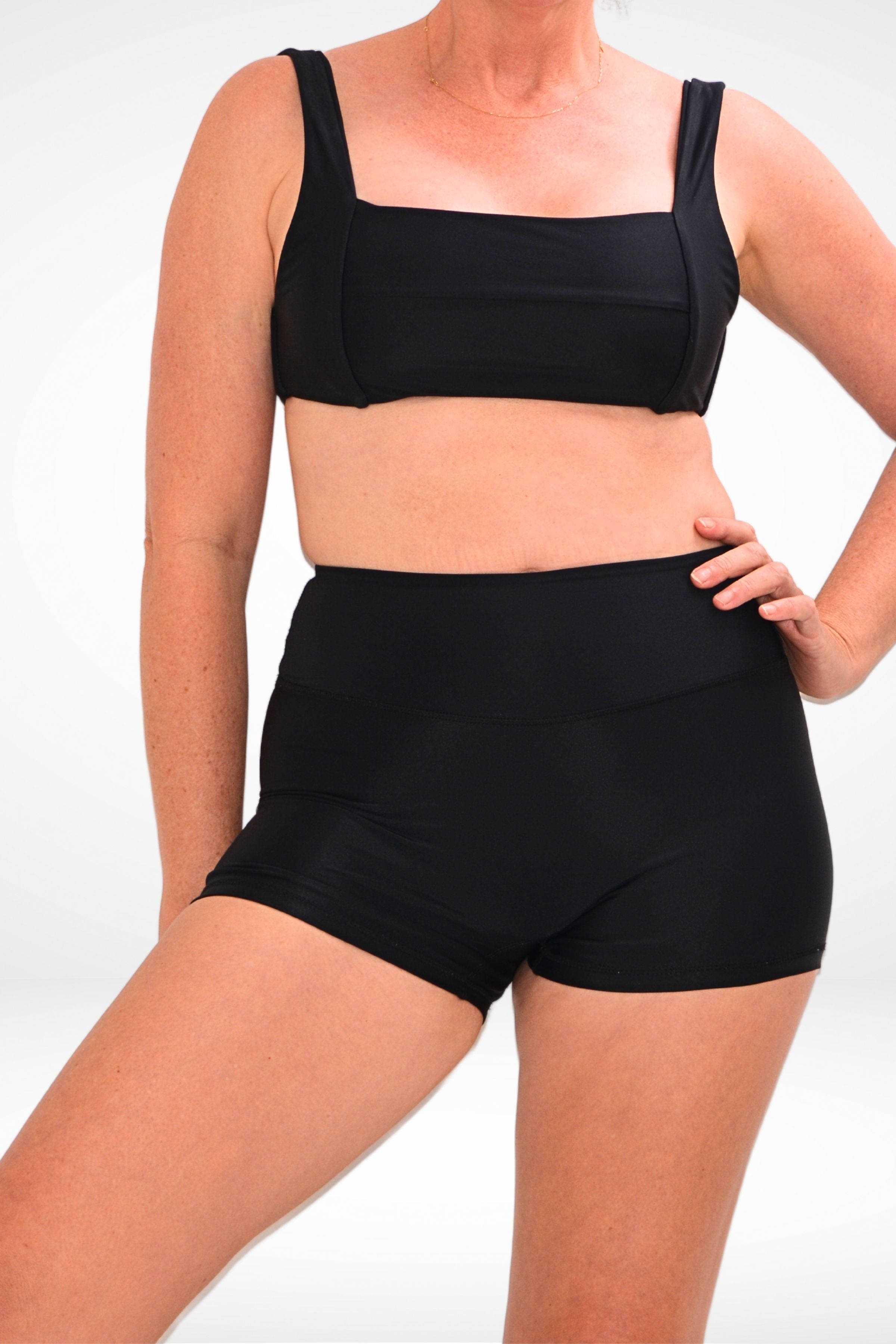 women wearing black square neck bikini top and black swim shorts
