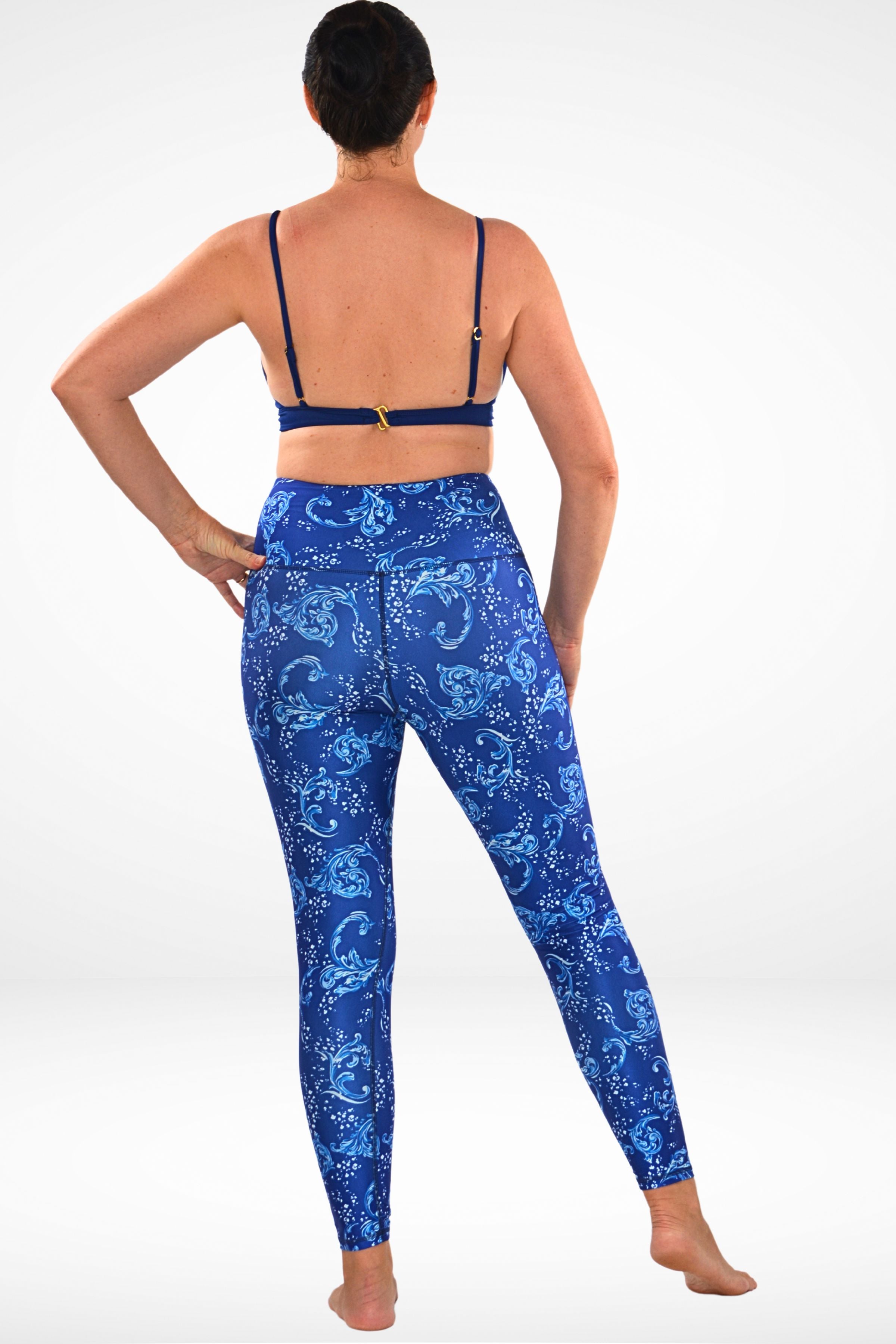 women wearing andavi swim blue and white print swim legging and navy blue triangle bikini top