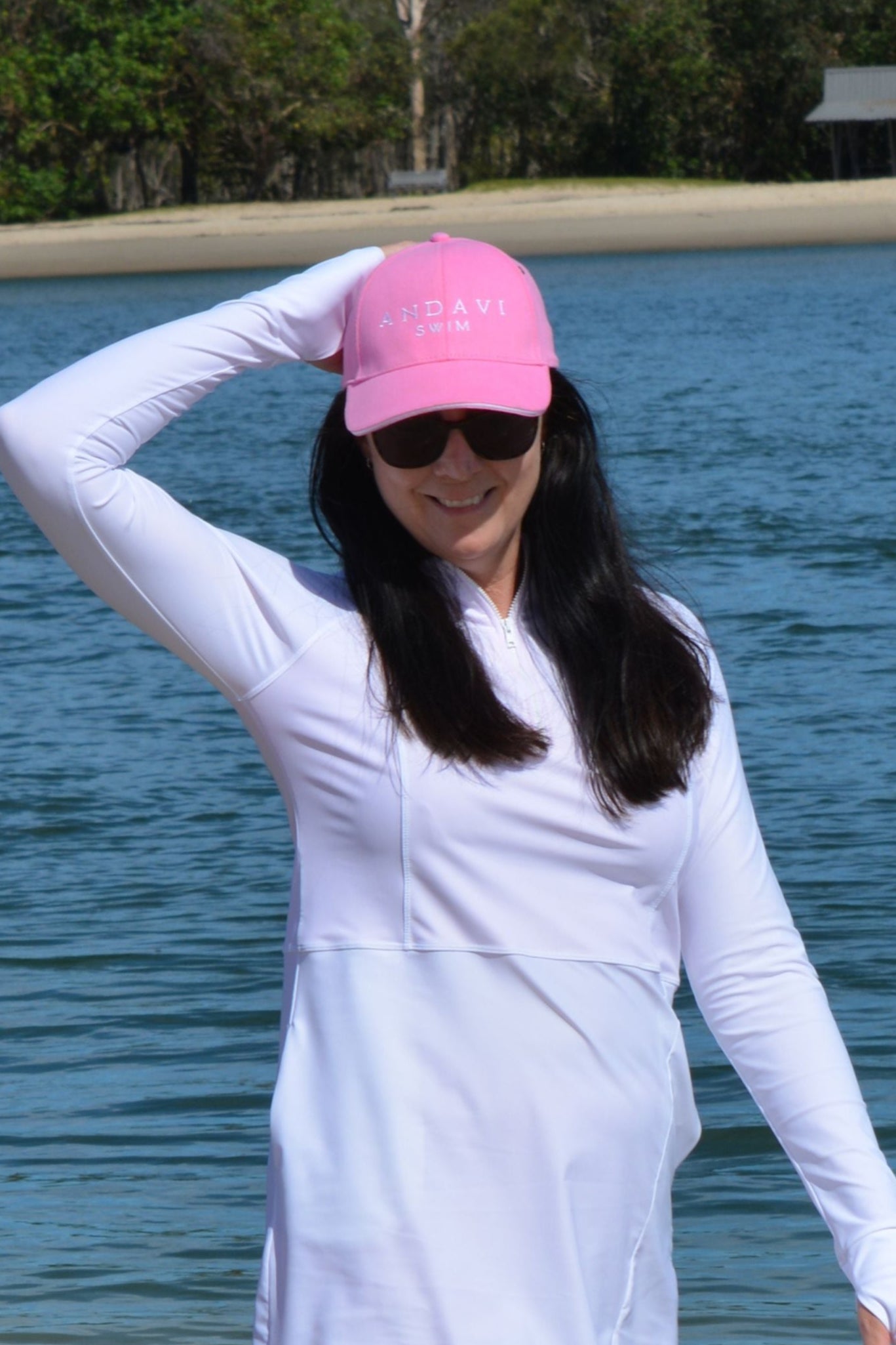 women at the beach wearing andavi swim pink cap and andavi swim long sleeve white swim active dress cover up