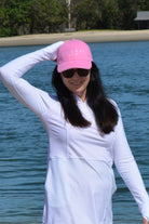 women at the beach wearing andavi swim pink cap and andavi swim long sleeve white swim active dress cover up