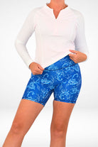 model wearing andavi white long sleeve upf50 rash guard and blue and white swim shorts