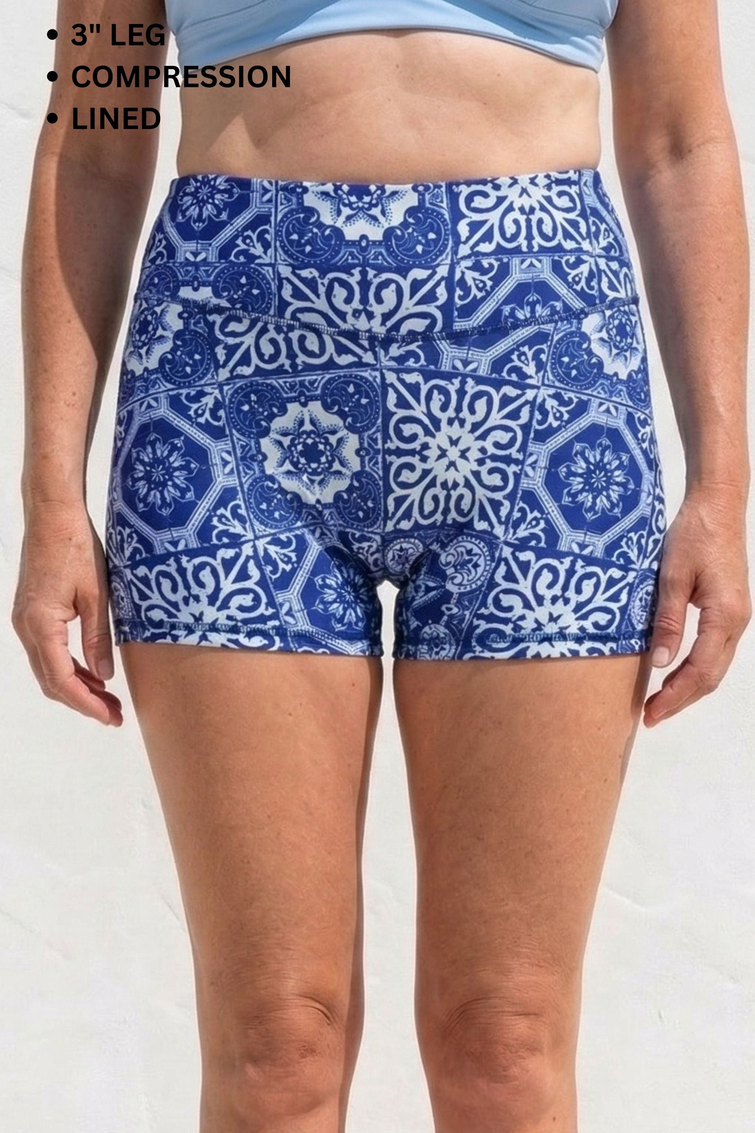 Blue patterned shorts worn by a person on a white background