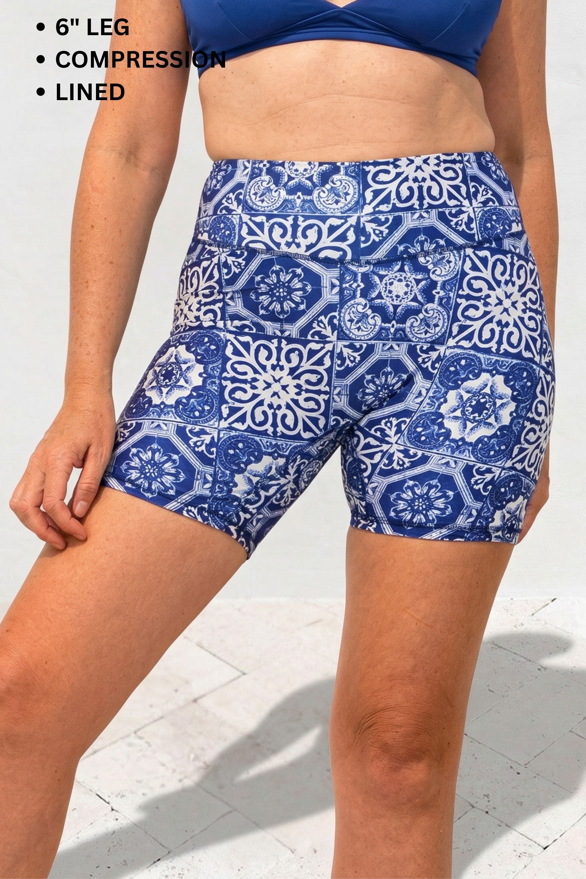 Blue patterned shorts worn by a person on a white background