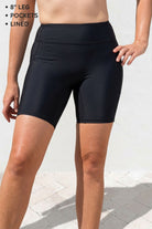 Black athletic shorts worn by a person on a light background