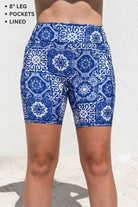 Blue and white patterned shorts on a person against a light background