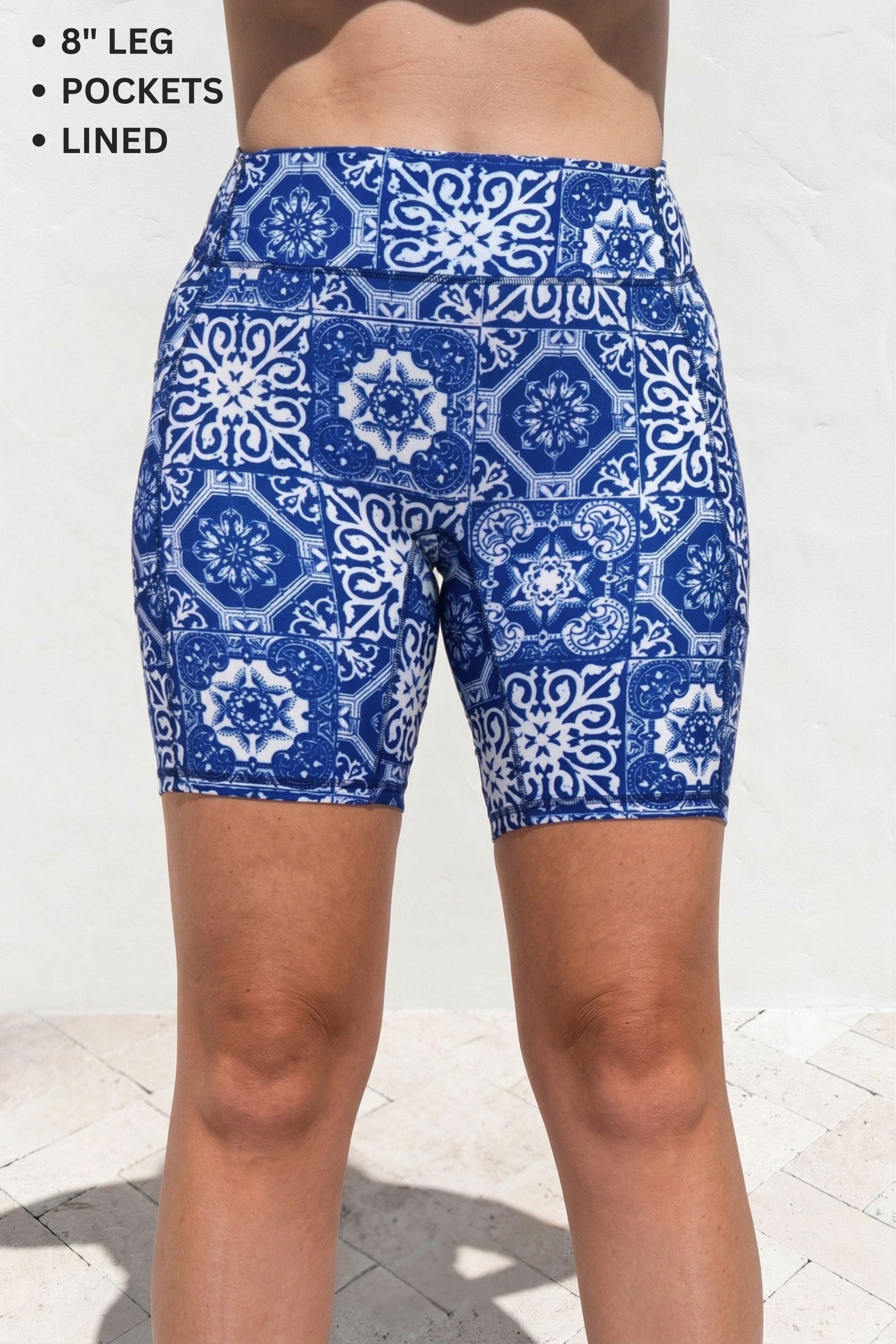 Blue and white patterned shorts on a person against a light background