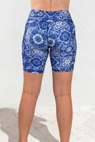 Blue and white patterned shorts worn by a person on a white background