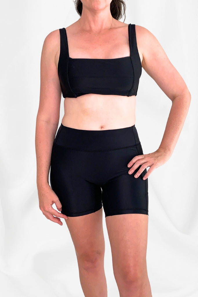 women wearing black bikini top and black swim bike shorts