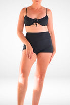 women wearing black underwire bikini top with front tie bow and black swim shorties