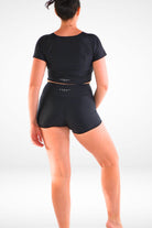 women wearing black short sleeve Adnavi Swinm rash guard and Black Andavi Swim swim active shorties