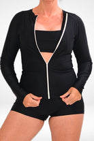 women wearing full zip black rash guard and swim shorts in black