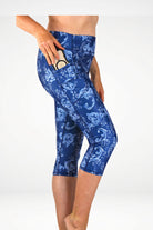 Blue patterned leggings worn by a person on a white background