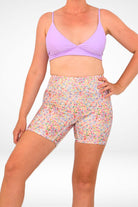 model wearing andavi floral compression swim short and lilac triangle bikini top