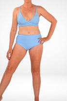 women wearing light  blue triangle bikini top with light blue full coverage bikini bottom