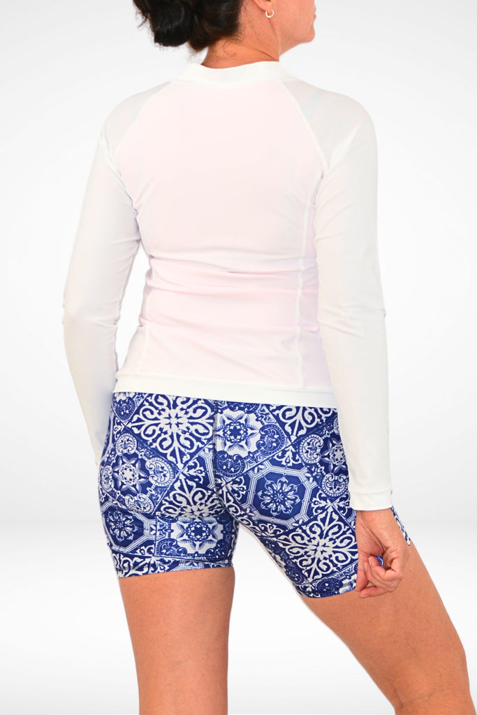 model wearing long sleeve upf50 andavi womens rash guard and navy bluie and white geometric compression swim active shorts 