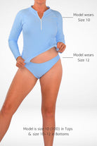 women wearing andavi light blue long sleeve rashie and light blue matching bikini bottom with size guide