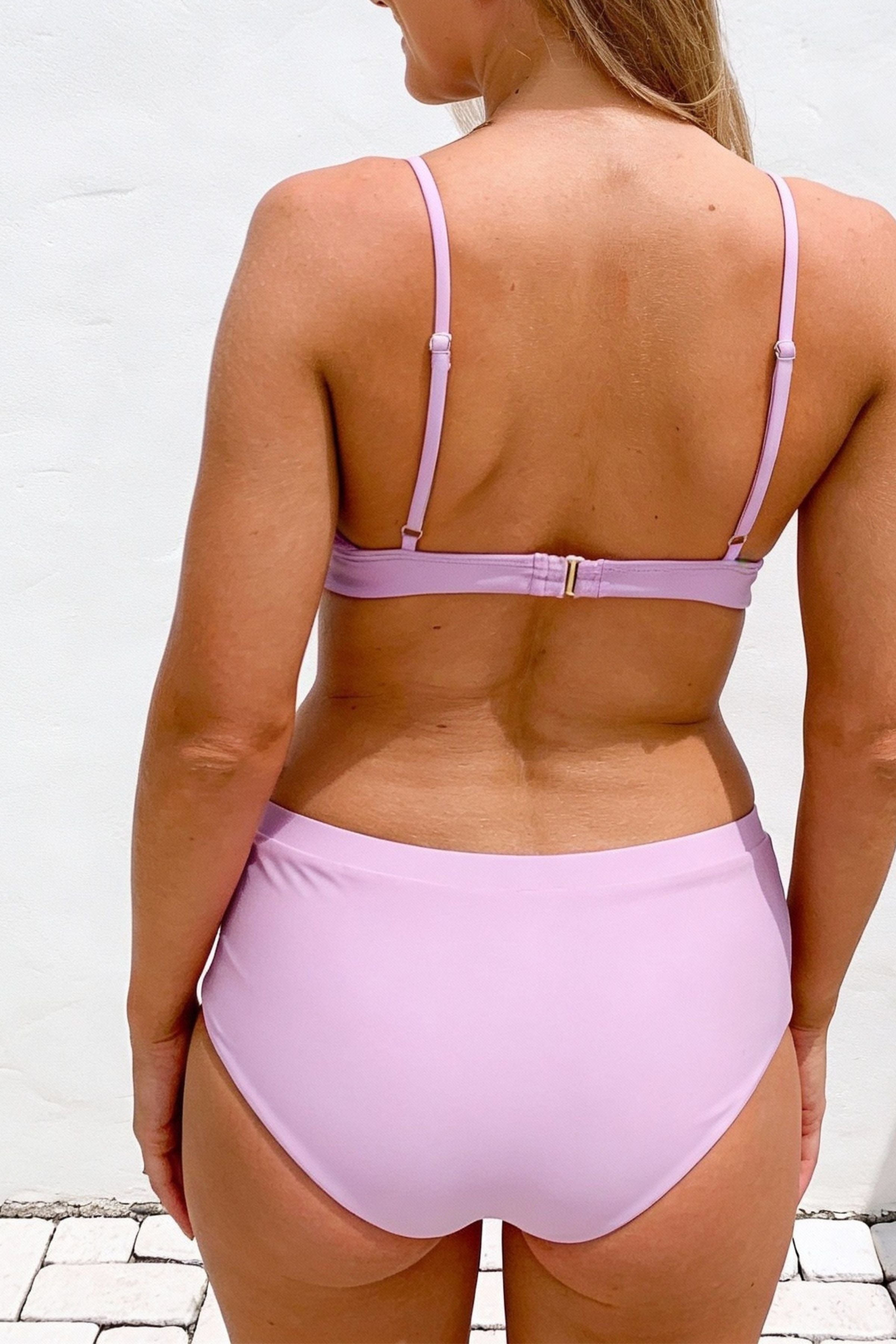 Person wearing a light purple bikini set against a white background