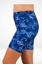 Blue patterned shorts worn by a person on a white background
