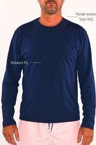 man wearing andavi swim long sleeve relaxed fit rash guard with size guide