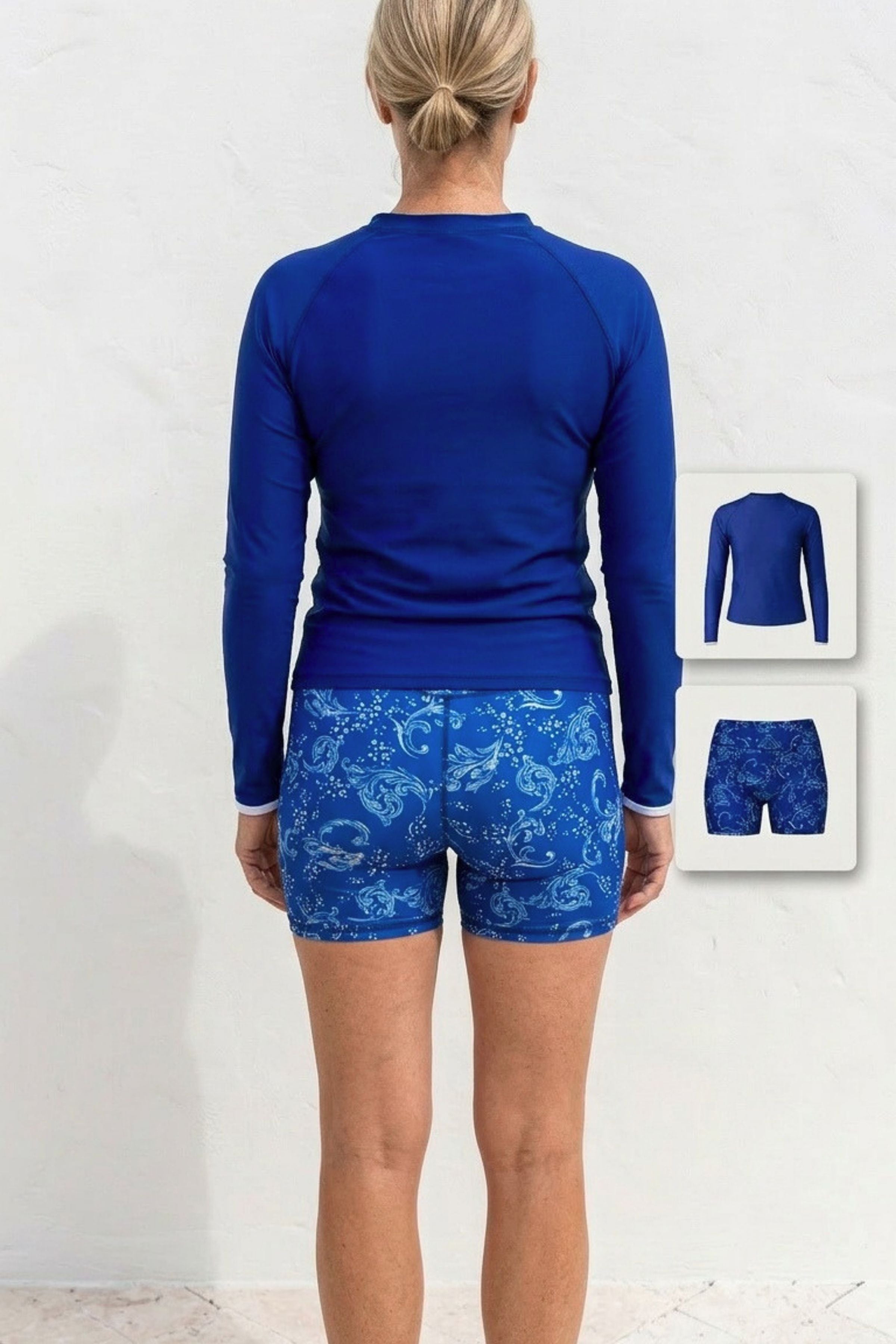 Person wearing a blue athletic outfit with long-sleeve top and patterned shorts on a white background.