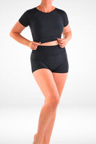 women wearing black short sleeve crop rashie and black swim shorties