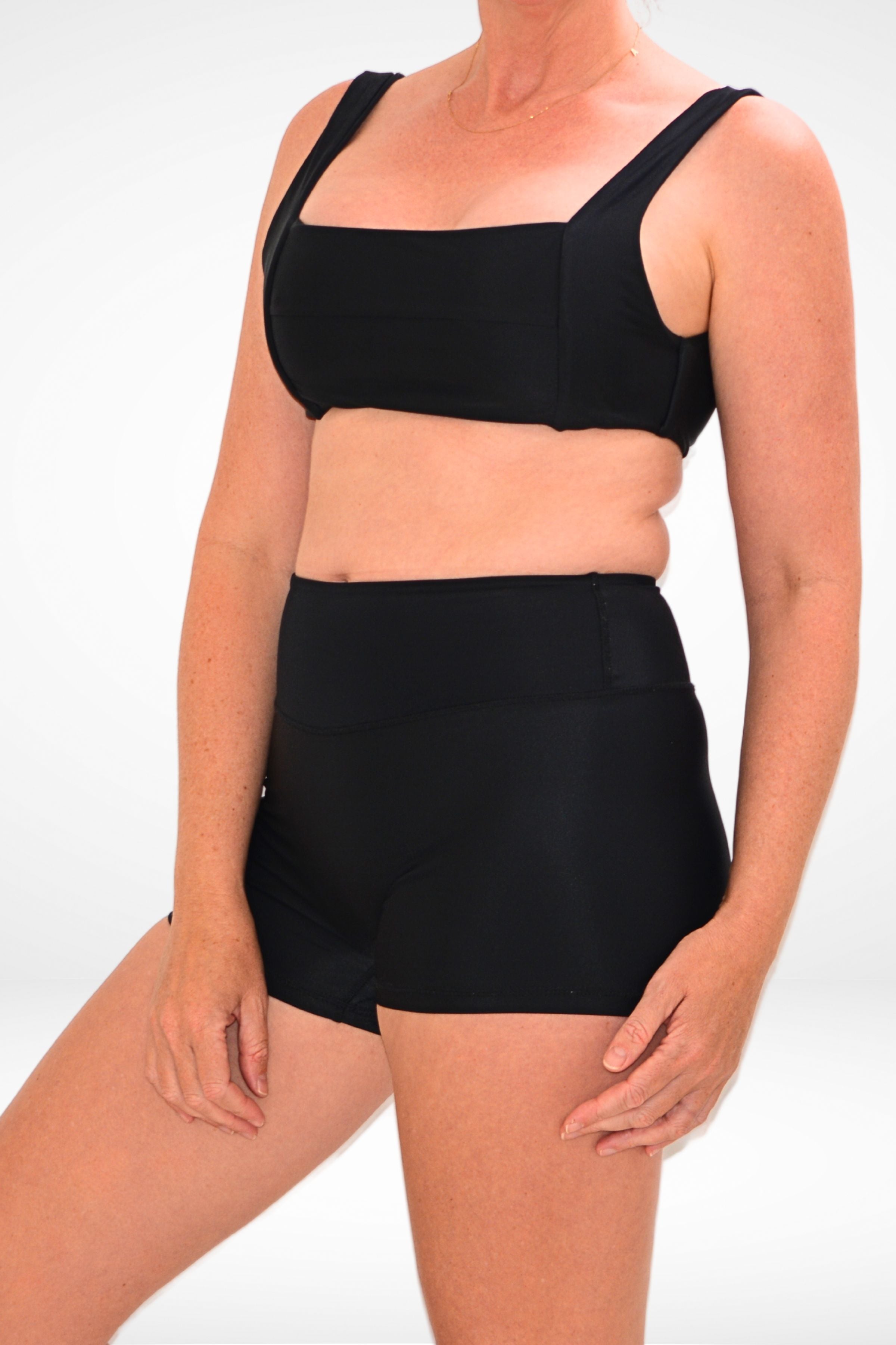 side on view of women wearing black square neck bikini top and black swim active shorties