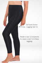 model wearing black swim legging size 12