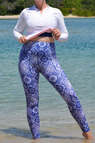 women wearing andavi white long sleeve rash guard and white and blue print high waist swim leggings