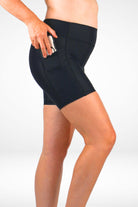 Person wearing black shorts on a white background