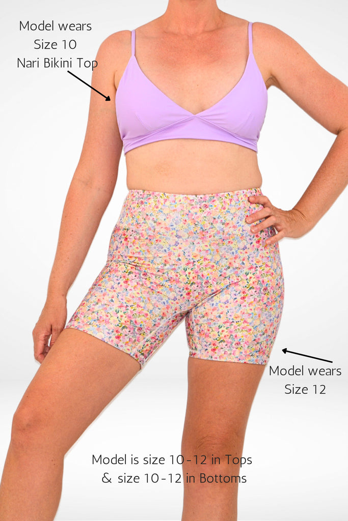 model wearing andavi compression floral swim short and lilac triangle bikini top