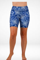Blue patterned shorts worn by a person on a white background