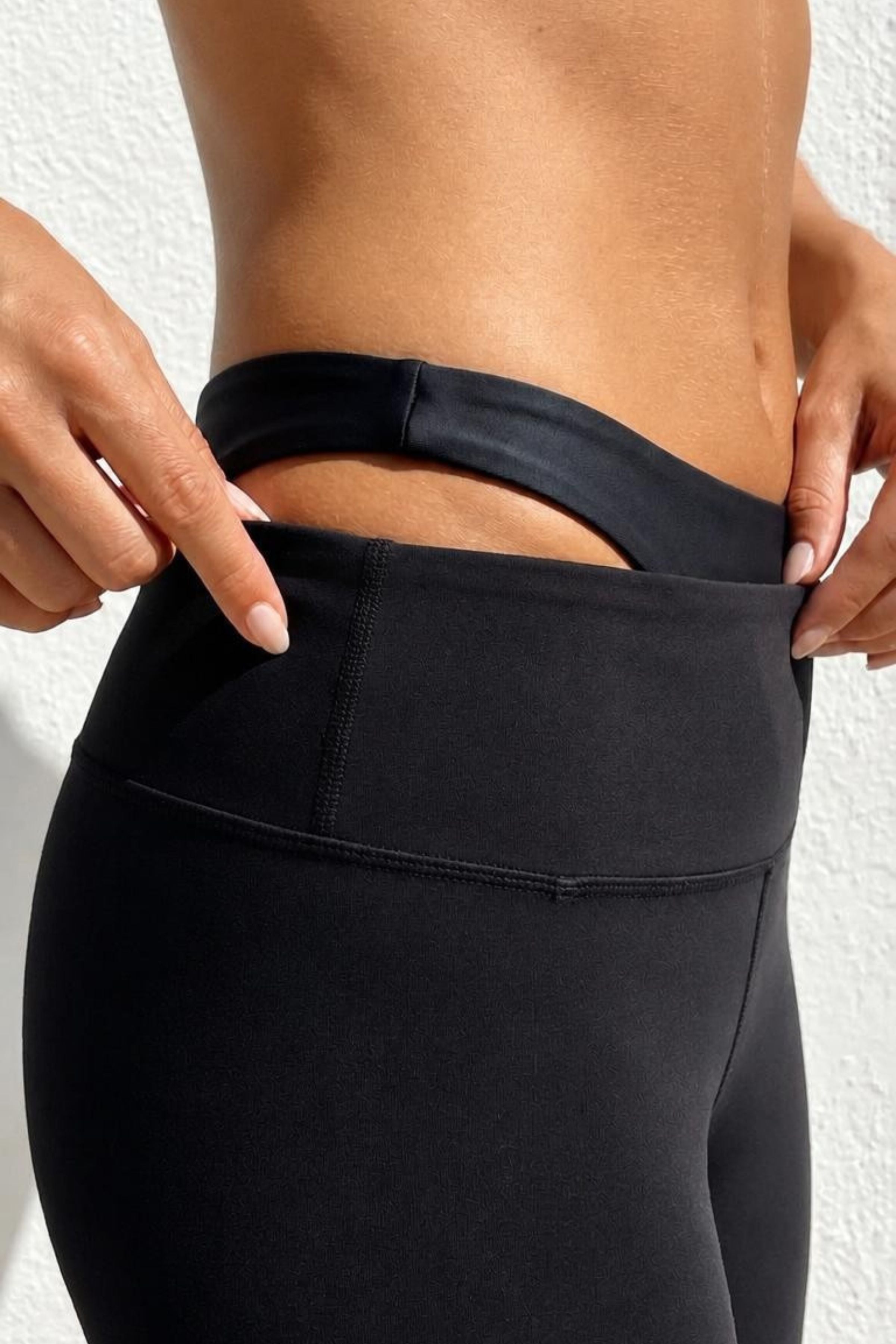 women wearing black leggings and black bikini bottom underneath