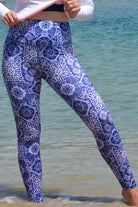 women at the beach wearing andavi white blue print swim leggings