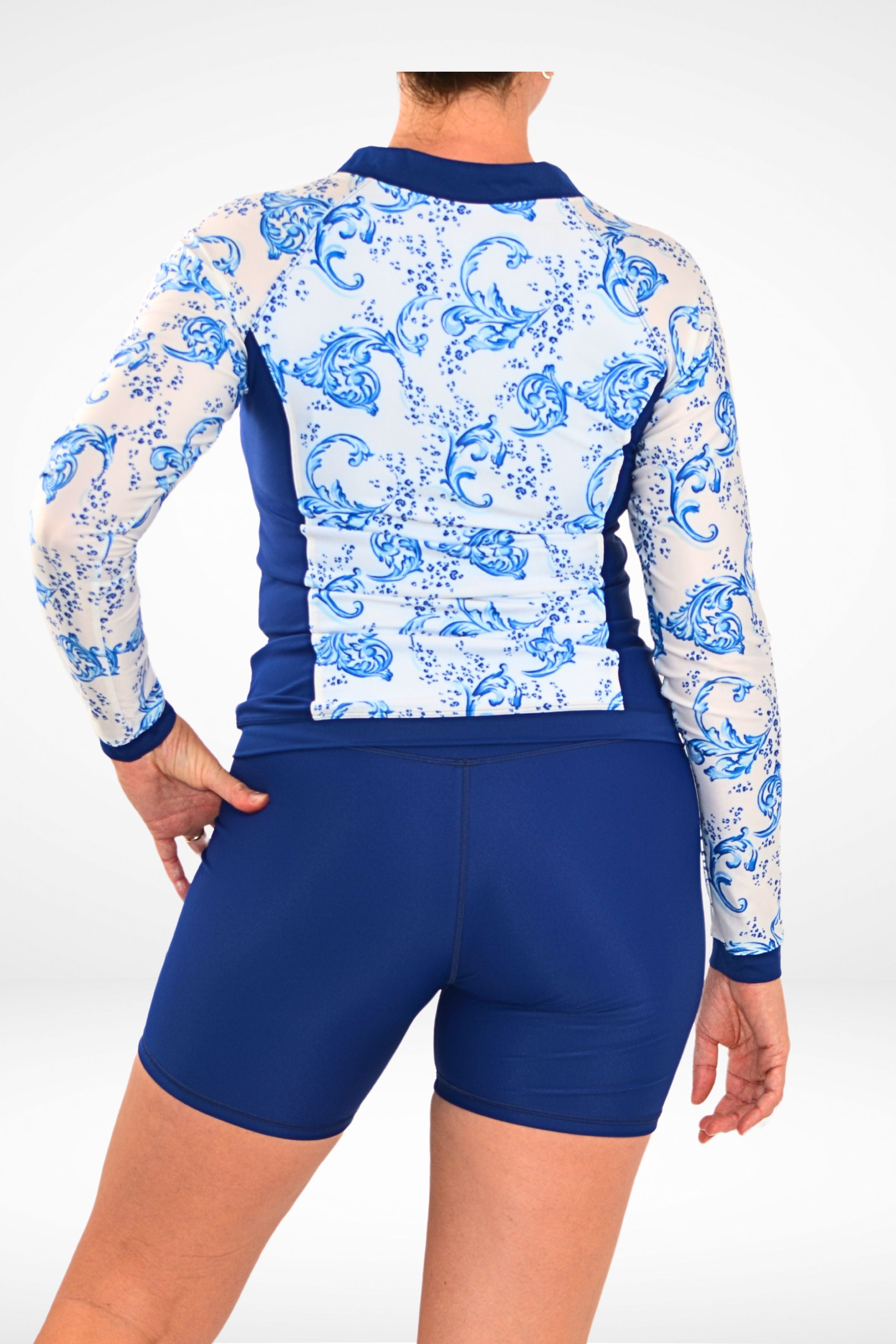 women wearing andavi navy blue and white long sleeve rash guard and navy blue long leg swim shorts 