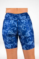 Blue patterned shorts worn by a person on a white background